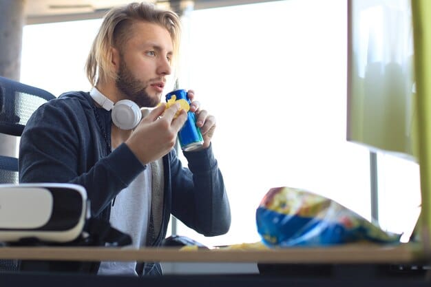 A lifestyle shot of a FIFA Esports player taking a break, stretching, and hydrating with a water bottle. The background shows a comfortable gaming setup and a calm, relaxed atmosphere.