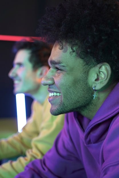 Close-up of a young, diverse gamer intensely focused on the screen during a FIFA Esports competition in a well-lit gaming arena in the US.