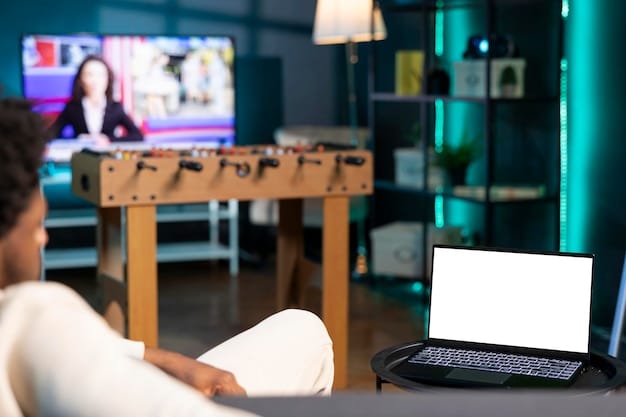 A shot of a US FIFA pro in a dedicated gaming space, surrounded by multiple monitors and gaming equipment. The room is well-lit and organized, showing the professional environment in which elite eSports athletes train.