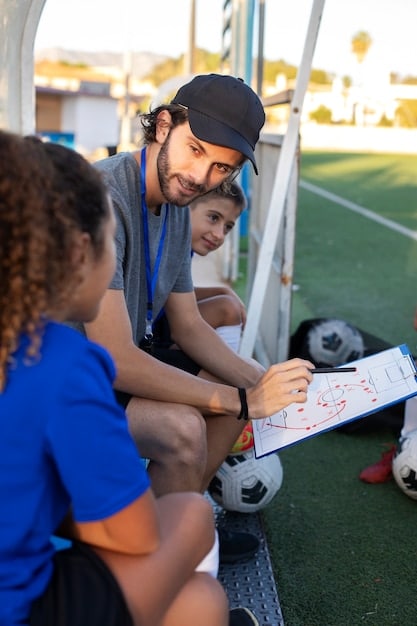 A diverse group of young soccer players training at a vibrant, modern youth academy pitch, demonstrating commitment to youth development.