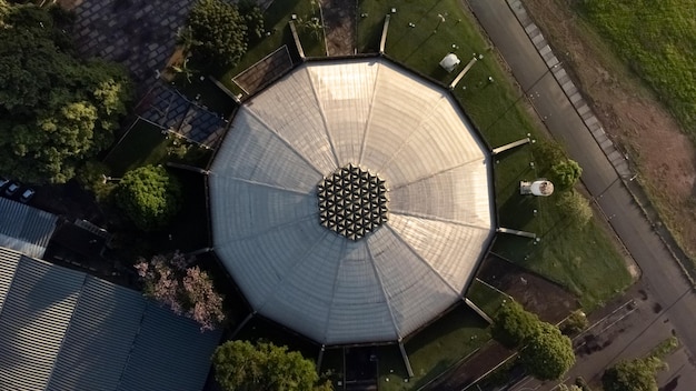 A detailed cutaway view of a stadium showing integrated rainwater harvesting systems, underground storage tanks, and greywater recycling pipes supplying water for irrigation and toilet flushing, with a focus on sustainable infrastructure.