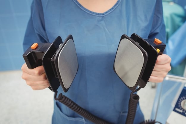 A close-up of a modern automated external defibrillator (AED) device with medical professionals in the background providing first aid to a fallen athlete on a football field. Emphasize readiness and critical care.
