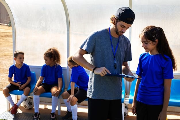 A soccer coach interacting with young players on a training pitch, emphasizing youth development and long-term investment.
