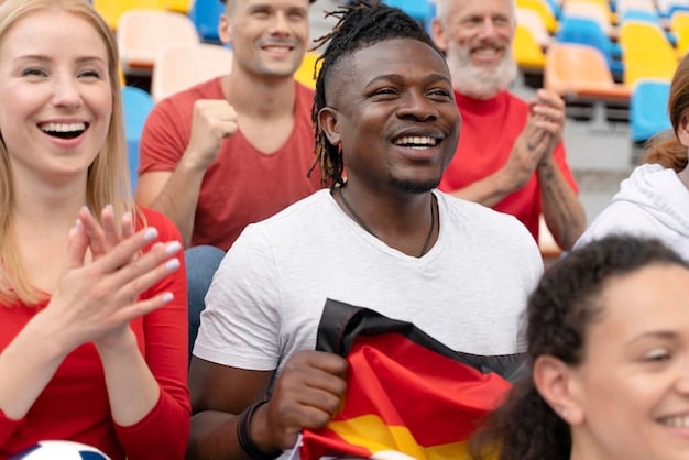 A diverse group of soccer fans from different backgrounds smiling and cheering together in a stadium, showcasing inclusivity and shared passion.