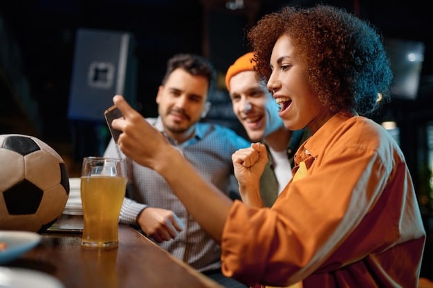 A group of US soccer fans in a sports bar, some looking frustrated at a TV screen showing a VAR review, others engaged in debate.