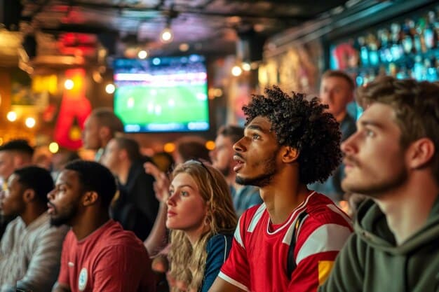 A bustling FIFA Fan Zone, showing a diverse crowd of people in team jerseys watching a match on a large screen, with food stalls and banners in the background.