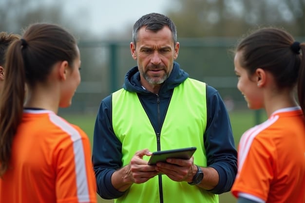 A young soccer player wearing a GPS tracking vest during a training drill, with a coach observing
