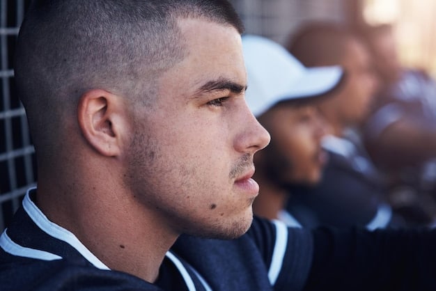 A close-up shot of a referee's face during a tense moment in a soccer game. The expression is focused, serious, and determined. The background is slightly blurred, showing players contesting the ball, emphasizing the referee's concentration on the game. This illustrates the stress of adhering to FIFA's Refereeing Standards: How They're Being Implemented and Evaluated in the US.