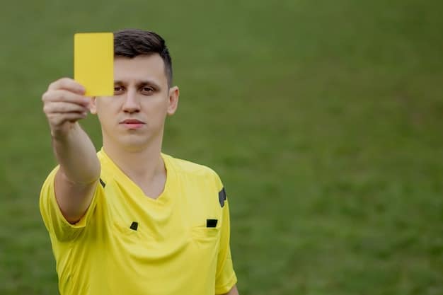 A close-up shot of a referee displaying a yellow card to a player during a heated US soccer game. The image focuses on the referee's decisive expression and the player's reaction. This illustrates the immediate consequences of violating fair play rules and underscores FIFA's Role in Promoting Fair Play: Examining Recent Controversies in US Matches.