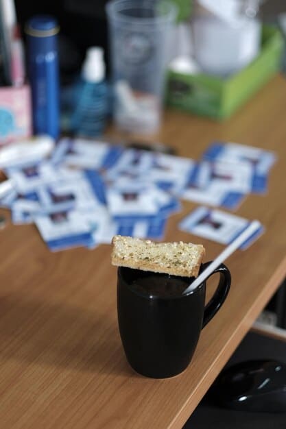 A close-up of a DIY coffee table decorated with team logos, coasters, and game-day snacks. The coffee table is surrounded by comfortable seating and sports-themed throw pillows. The image highlights how The Ultimate Fan Zone Makeover: Transform Your Living Room into a Stadium Experience for Under $500 can be achieved with creative and personalized decor.