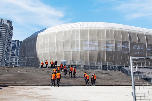 A modern soccer stadium being constructed in a major US city, with construction workers and heavy machinery visible. The image emphasizes the infrastructural investments associated with hosting the 2026 World Cup and its potential impact on the World Cup Legacy: How the 2026 Tournament Could Shape the Future of Soccer in the US.