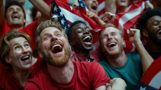 A crowd of US soccer fans cheering and waving American flags at a USMNT game. The atmosphere is energetic and supportive.